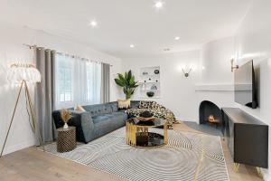a living room with a couch and a fireplace at Studio City Contemporary Villa with Pool Sleeps 10 in Los Angeles