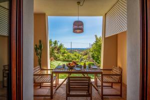 a dining room with a table and chairs and a window at Sweet Life in Golf Is Molas in Pula