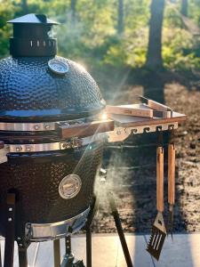 a bbq grill with a smoker on top of it at NIEUW Eco design bosvilla met sauna en xl tuin in Wateren +16 photos