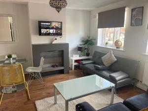 a living room with a couch and a fireplace at FilmonHomes in Oldbury