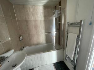 a bathroom with a sink and a bath tub at FilmonHomes in Oldbury