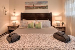 a bedroom with a large bed with two lamps at Desert Gardens #1 in Moab