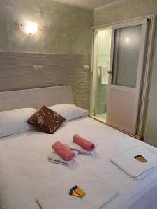 a white bed with two pillows on top of it at Villa Kolorina in Dubrovnik