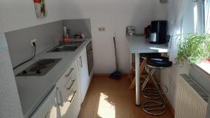 a small kitchen with a sink and a counter at Ferienwohnung Funkner 