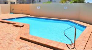 a large swimming pool with a brick patio at Oceanic 19 - linen not included in Forster