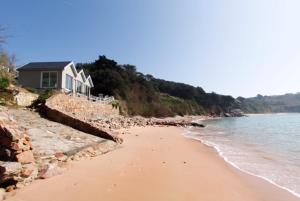 a house on the shore of a beach at Portelet Bay in St. Brelade