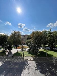 an overhead view of a street with trees and a building at Avenue Apart in Lviv