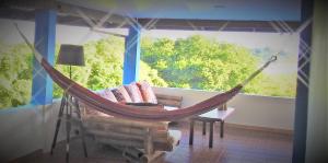 a hammock in a room with a large window at VISTA CARIBE in Portobelo