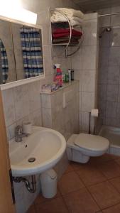 a bathroom with a sink and a toilet at Ferienwohnung Funkner 