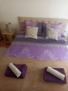 a purple bed with two pillows on top of it at Sleep & fly - Single room with shared bathroom in Sarajevo