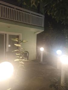 a house with two lights on the porch at night at Sleep & fly - Single room with shared bathroom in Sarajevo