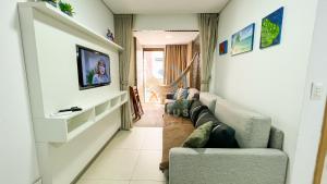 sala de estar con sofá y TV en Eco Summer Tambaú - Apartamentos de 2 Quartos por Genius Flats, en João Pessoa