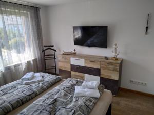 a bedroom with a bed and a tv on a wall at Ferienhaus Eckernfeld Bremerhaven in Bremerhaven