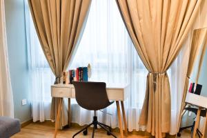 a desk and a chair in front of a window at Kuantan Imperium Residence Cityview With Netflix in Kuantan