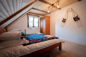 a bedroom with a bed in a attic at Casa Veche Breb in Breb