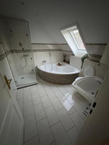 łazienka z wanną, toaletą i umywalką w obiekcie Ferienwohnung am See w mieście Heilshoop