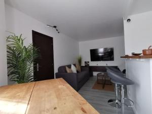 a living room with a table and a couch at Appartement Paris Roissy Astérix in Louvres
