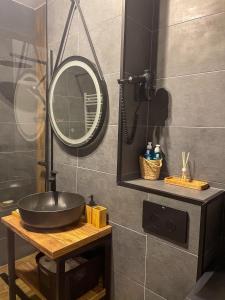 a bathroom with a sink and a mirror on a table at Puzzle Studio in Bucharest