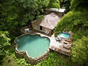 an aerial view of a resort with a swimming pool at Las Cabañas del Rio in Minca