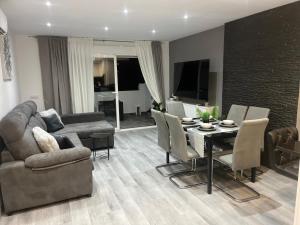 a living room with a couch and a table and chairs at Apartamento Cristina 3 - Playa Arenal Bol in Calpe