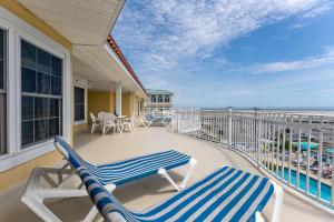 a balcony with two lounge chairs and the ocean at Nw Condo W Ocean View, Sundeck, Pool in North Wildwood