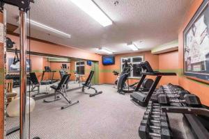 a fitness room with treadmills and exercise equipment at Lux 2BR 5BD Suite Mountain view! in Canmore