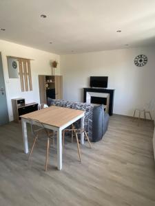 ein Wohnzimmer mit Tisch und Couch in der Unterkunft Appartement 21 in La Roche-Posay + 3 Fotos