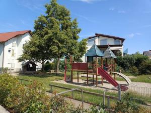 a park with a playground with a slide at Ferienwohnung Latscha - 2 Zimmer Wohnung mit Klimaanlage,Balkon, Kinderspielplatz in Ettenheim