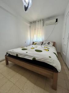 a bedroom with a bed with a white comforter at 3-х комнатная квартира у моря в Хайфе in Haifa