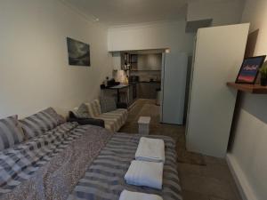 a living room with a bed and a couch at Studio Apartment in Kew in Kew