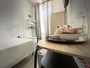 a table with a pile of dishes on it in a bedroom at Affittacamere Everest in La Spezia +49 photos