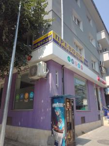 a purple building with a phone booth in front of it at Стеди - стая за гости in Varna City