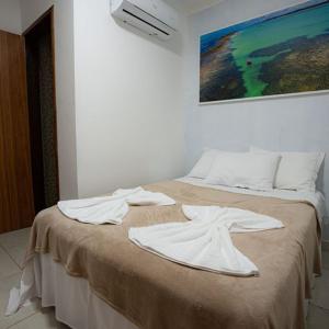Ένα ή περισσότερα κρεβάτια σε δωμάτιο στο Pousada Villa Costeira