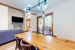 a dining room with a wooden table and chairs at King's Crown in Breckenridge