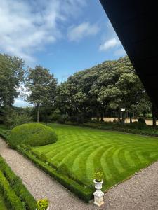 a green lawn with a vase in the middle at The Old Bushmills Barn in Bushmills
