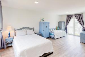 a bedroom with a white bed and a blue cabinet at Ocean Isles #119 in Marathon +37 photos