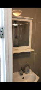 a bathroom with a sink and a mirror at W13 x Weekly Monthly Discount in London