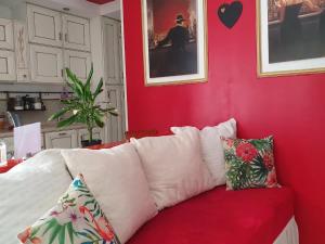 a red living room with a white couch with pillows at Casa Magnolia in Varese