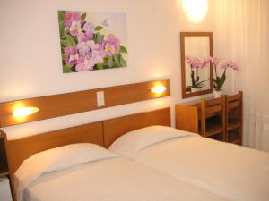 Postel nebo postele na pokoji v ubytování Danae Hotel