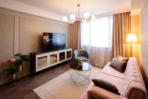 a living room with a couch and a television at Luxurious Apartment, Best View in Timişoara