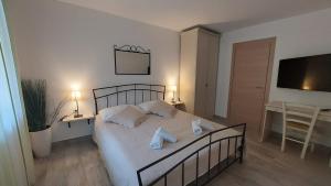 a bedroom with a bed with two towels on it at Apartments Nicole in Pula
