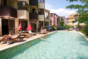 a group of people in a swimming pool in a building at Hotel Lira in Sunny Beach