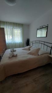 a large white bed in a bedroom with a window at Apartments Nicole in Pula