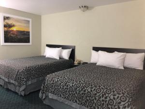 a hotel room with two beds and a picture on the wall at Elevation Lodge in South Lake Tahoe