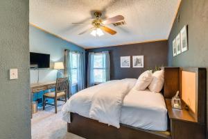 a bedroom with a bed with a ceiling fan and a desk at Pet-Friendly Ocala Vacation Rental with Patio! in Ocala