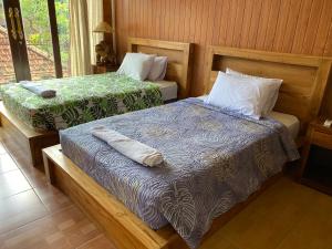 Postel nebo postele na pokoji v ubytování wahyu accomodation