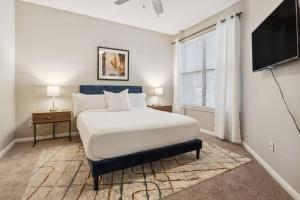 a bedroom with a large bed and a television at 1001 Ross Avenue in Dallas