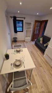 a white table and chairs in a living room at Les Bossons Studio in Chamonix