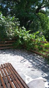 a wooden fence and a bench in a park at Vidiecky domček na samote 