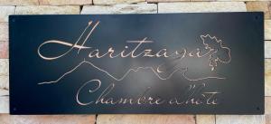 a sign for a restaurant with a mountain on it at HARITZAGA chambre d'hôte avec terrasse in Biarritz